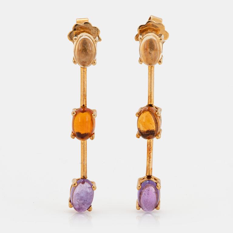 A pair of 18K gold earrings set with cabochon-cut citrines and amethysts.