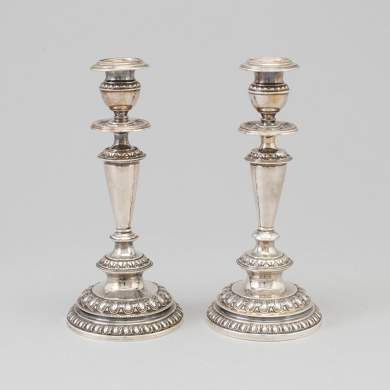 A pair of silver candle sticks, dated 1903.