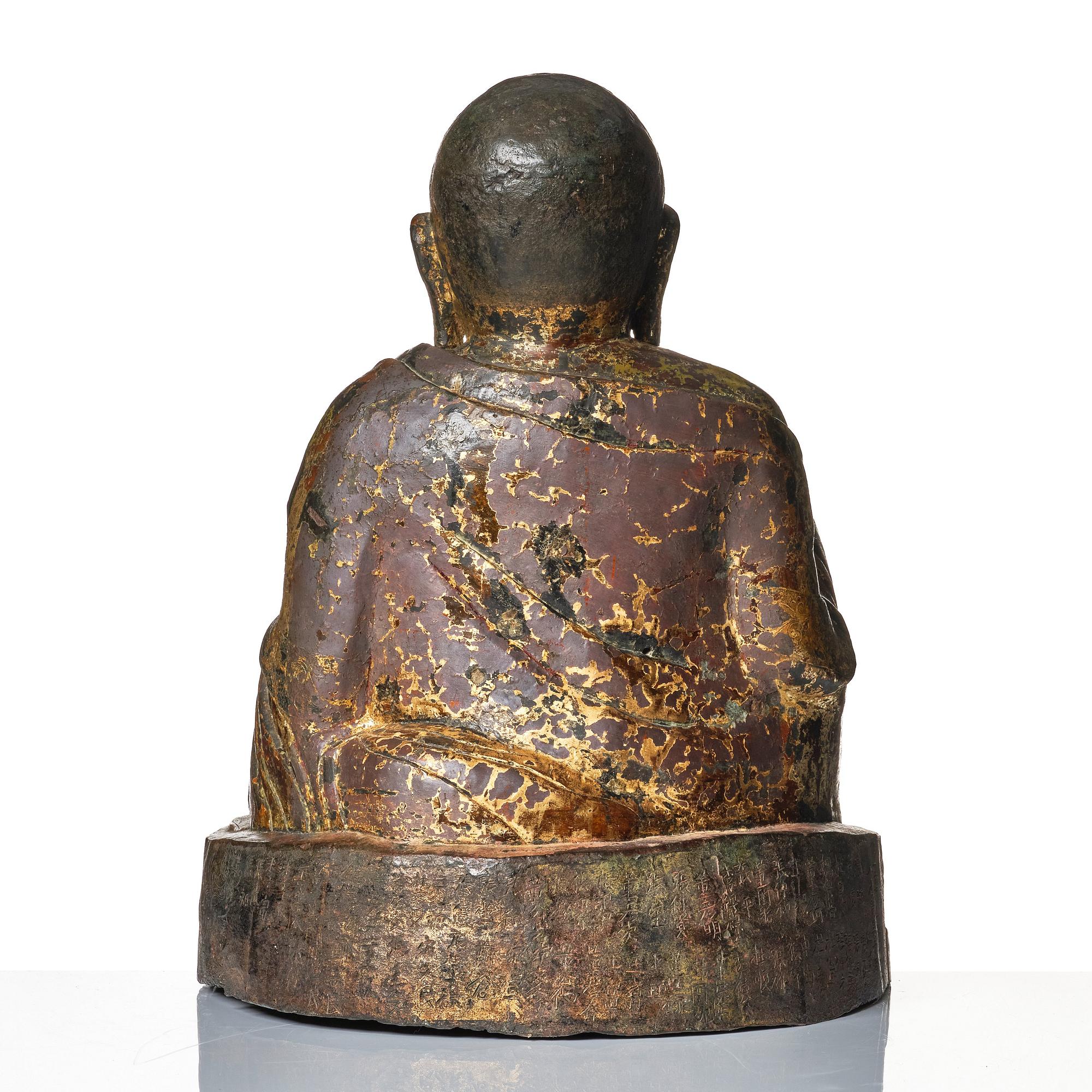 A large seated bronze figure of Budai, Ming Dynasty, dated to the fifth year of Jiajing (1526).