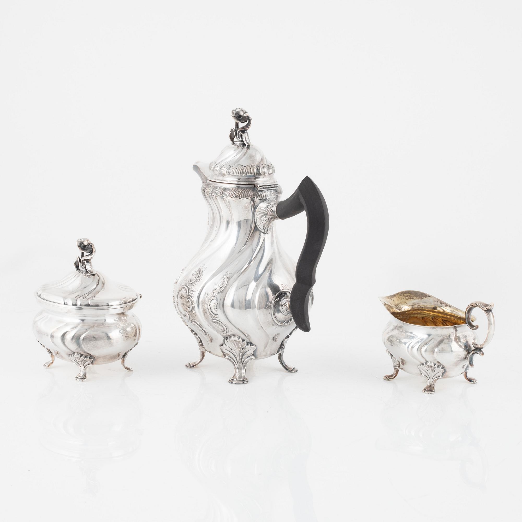 A silver coffee pot with creamer and sugarbox. CG Hallberg, Stockholm 1946.