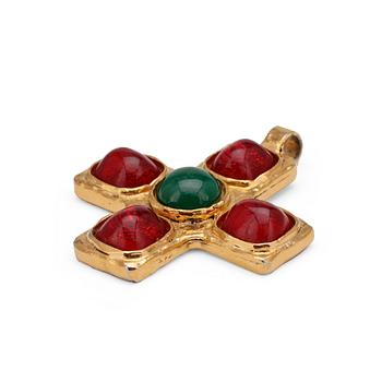 CHANEL reportedly, a gold colored pendant with red and green stones.