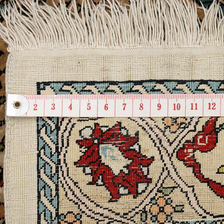 A Hereke silk rug, c. 73 x 52 cm.