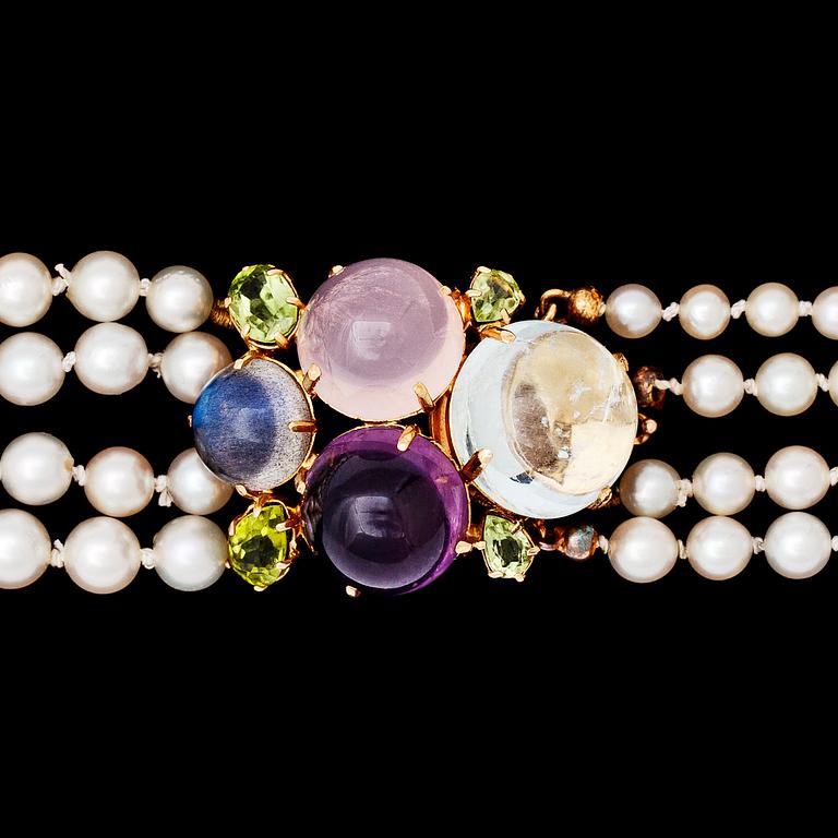 A four strand cultured pearl necklace with cabochon cut amethyst, rose quartz and aquamarine.
