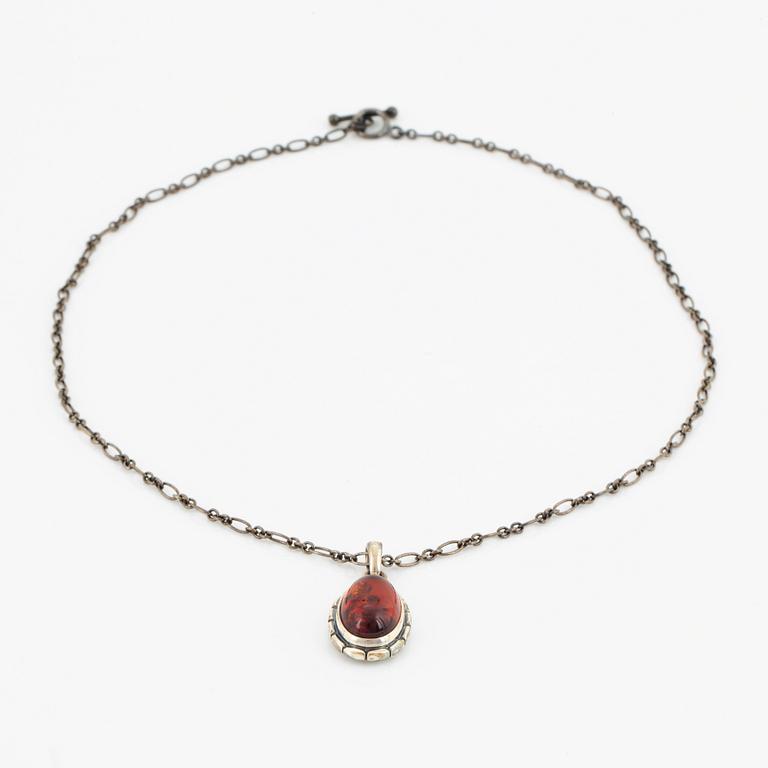 A Georg Jensen silver and cabochon-cut amber necklace.