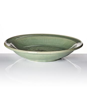 A large celadon glazed dish, Ming dynasty (1368-1644) or later.