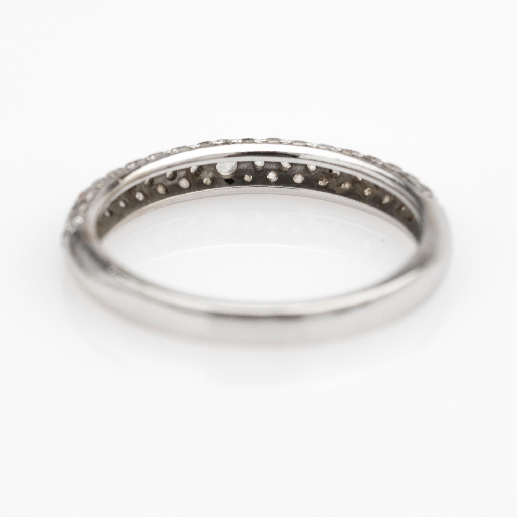 Ring, 14k white gold with brilliant-cut diamond and white stones.