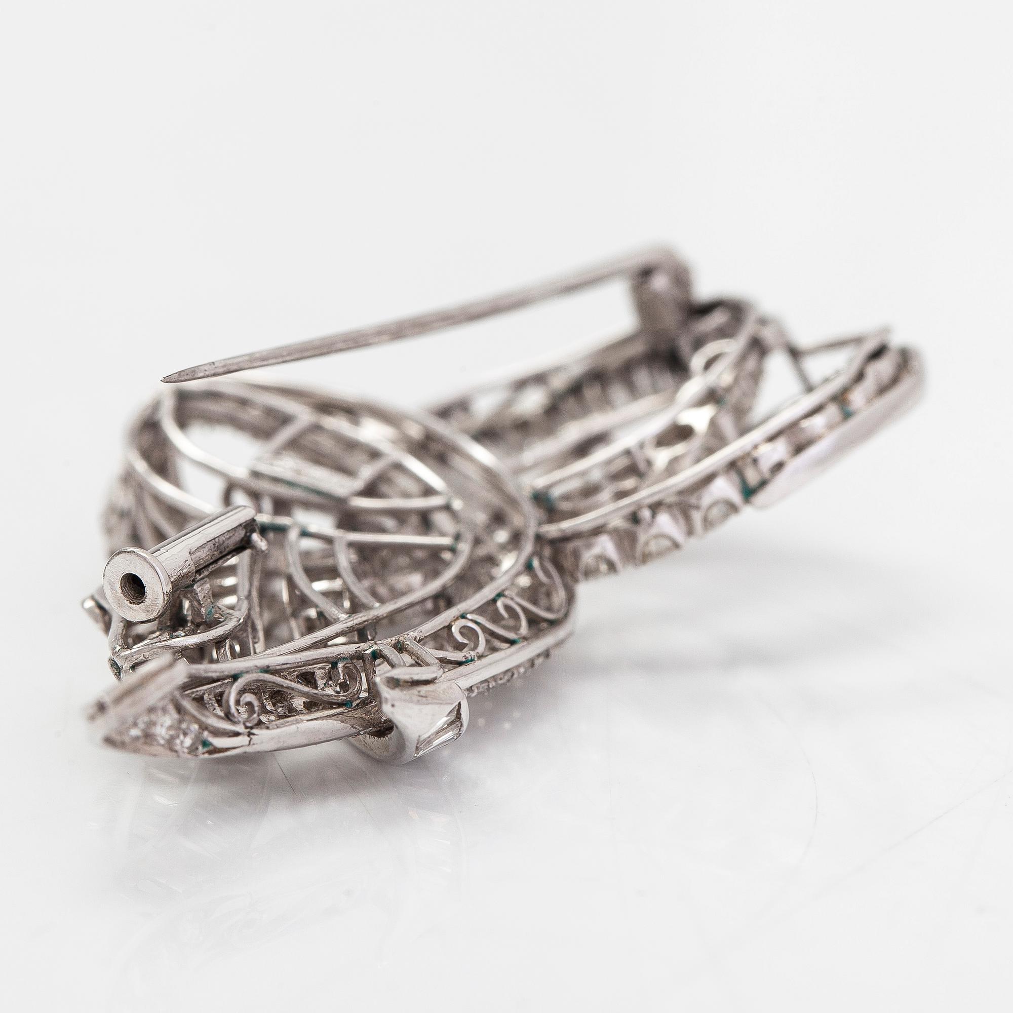 A platinum brooch, set with brilliant, baguette and eight-cut diamonds totalling approx. 7.21 ct. With certificate.