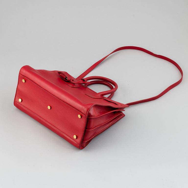 Saint Laurent, a red leather 'Sac du Jour Small' bag.