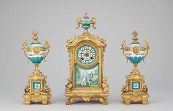 446. A Louis XVI style gilt bronze and porcelaine table clock and a pair of urns with covers.