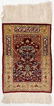 A silk and metal Hereke rug, West Anatolia, c. 58 x 39 cm.