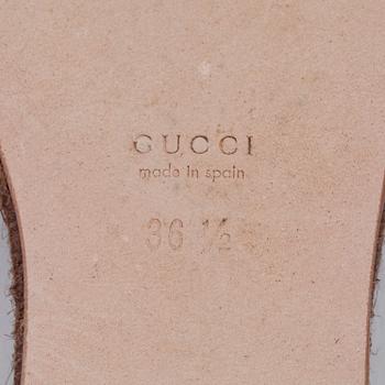 GUCCI, a pair of brown sandals.
