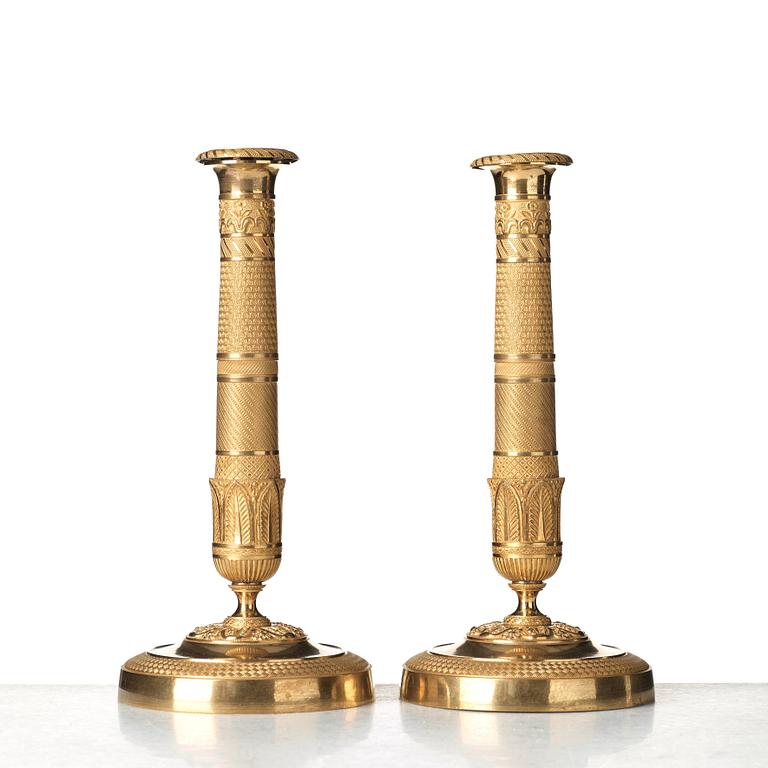 A pair of French Empire early 19th century candlesticks.