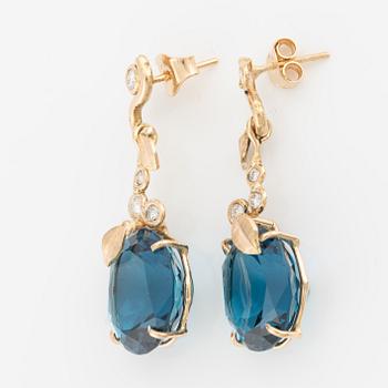 Earrings with blue topazes and brilliant-cut diamonds.