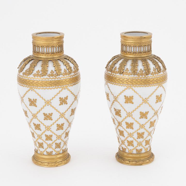 A pair of brass-mounted porcelain  vases, Sèvres mock marks, around 1900.