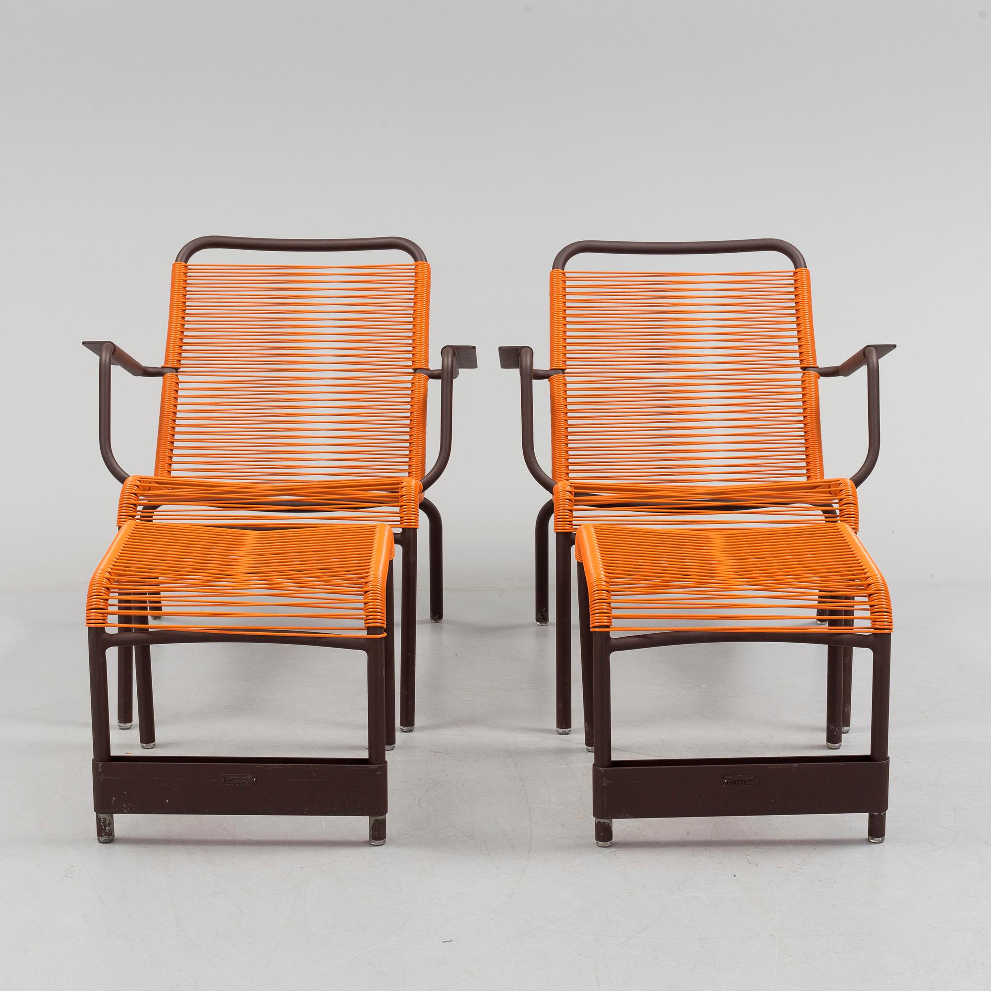 a pair of FRÉDÉRIC SOFIA "Saint Tropez" lounge chairs with footstools, by Fermob.