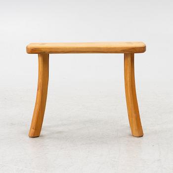A solid pine stool, signed RO -99, Sweden.