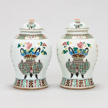 A pair of famille rose jars with covers, China, early 20th Century.