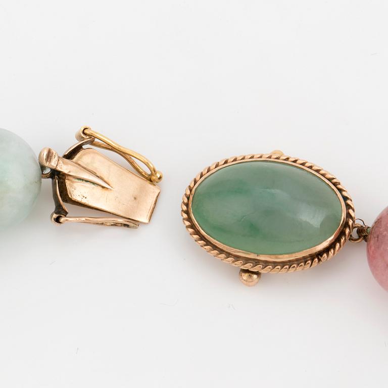 A necklace of multi-coloured stone beads with an 14K gold clasp.