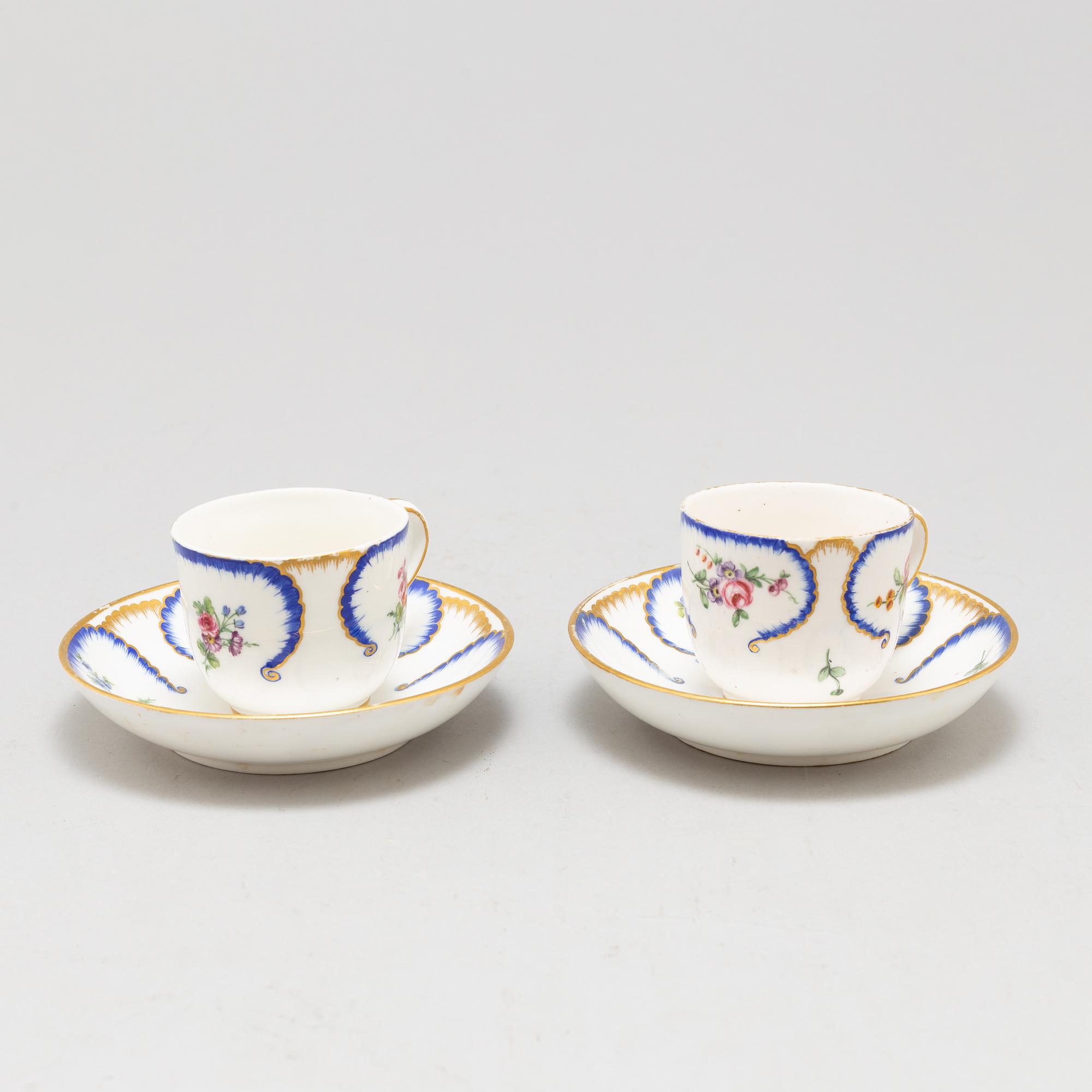 A pair of enamelled cups with dishes, France, Sèvres, 1780s.