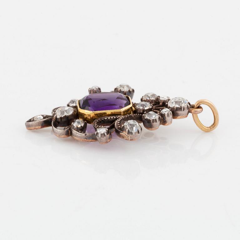 A silver and gold pendant set with a faceted amethyst and old- and rose-cut diamonds.