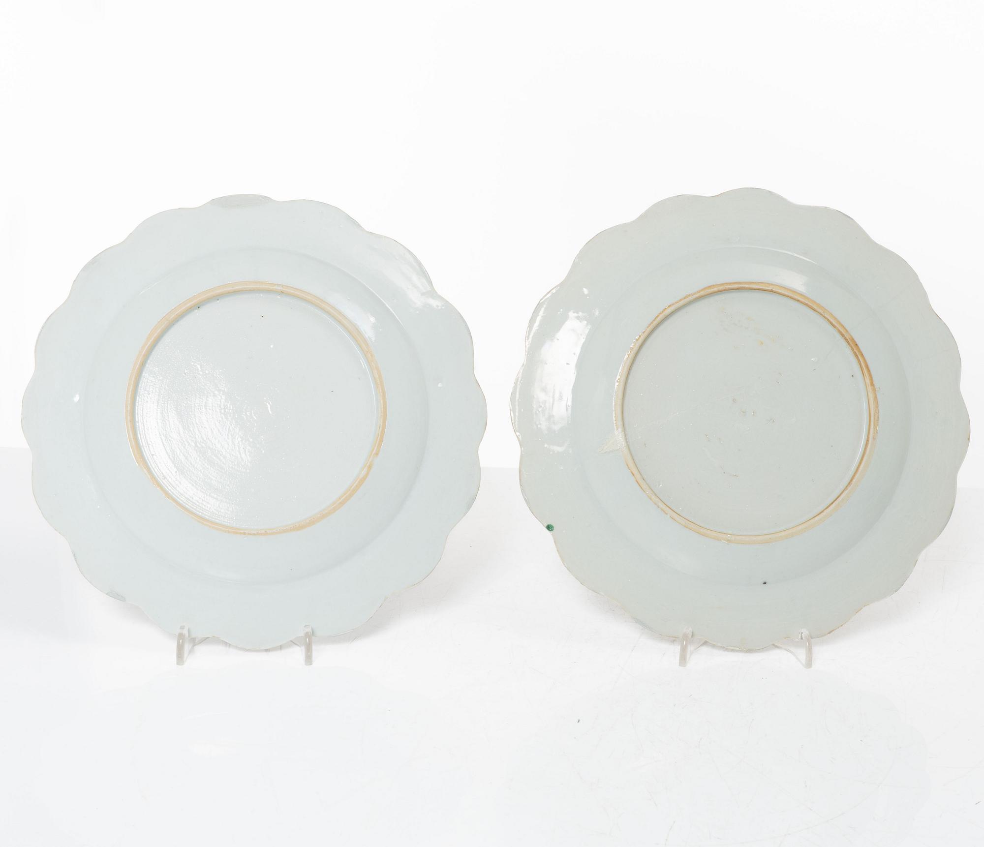 A pair of Chinese famille rose teacups with saucers and a pair of plates and two dishes, Qing dynasty, 18th century.