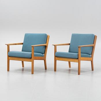 Hans J Wegner, a pair of oak 'GE-265'
easy chairs, Getama, Gedsted, Denmark.