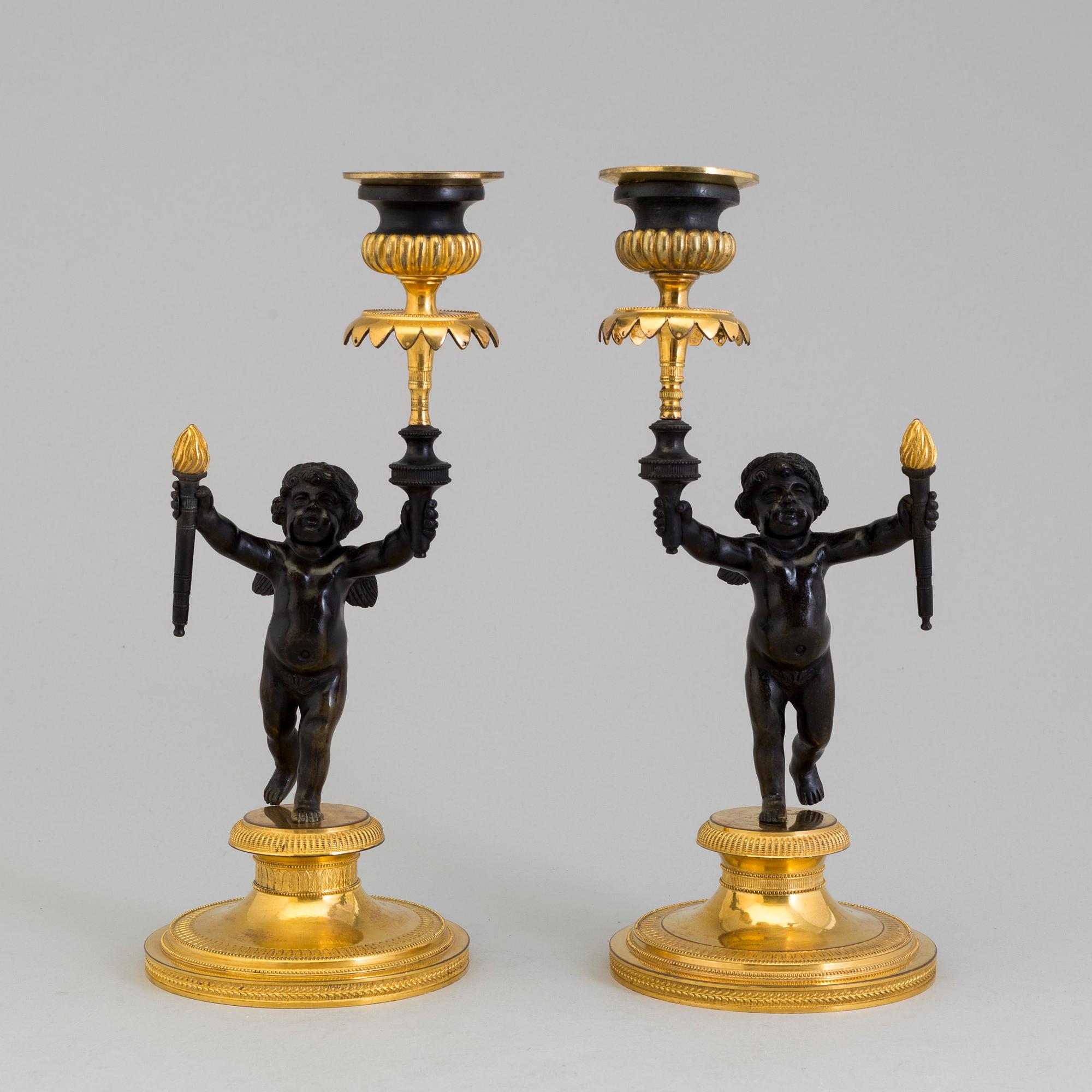 A pair of late 19th century, gilded bronze, Empire style, candle sticks.