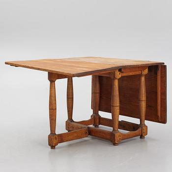 A drop-leaf table, 18th Century.