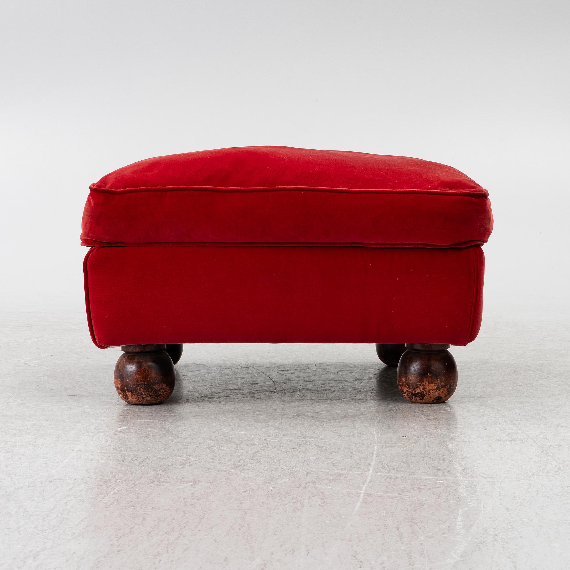 A pair of Howard-style armchairs and a footstool, late 20th century.