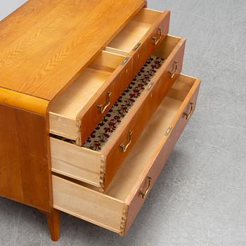 An elm wood venered chest of drawers mid 20th century.