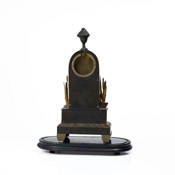 A French Charles X ormolu and patinated bronze mantel clock, ca 1820's.