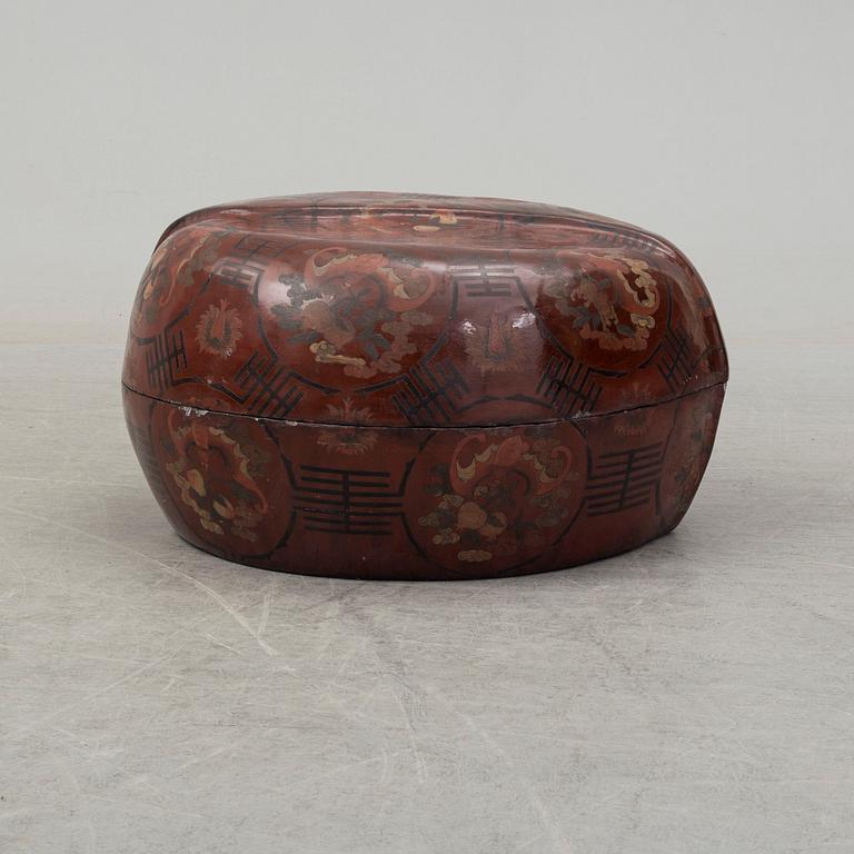 A massive Japanese wooden and lacquered box with cover, in the shape of a peach, early 20th century.