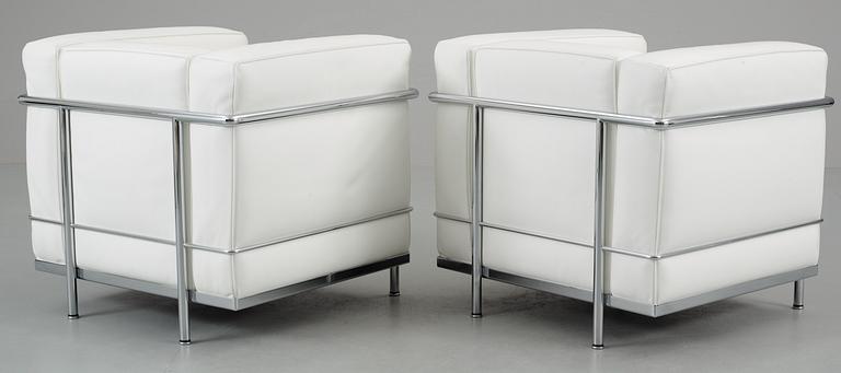 A pair of Le Corbusier, 'LC2' chromed steel and white leather easy chair, Cassina, Italy.