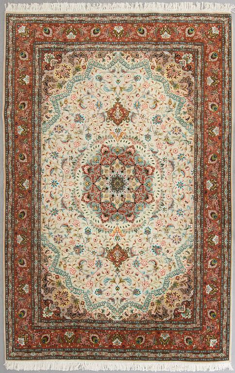 A carpet from Tabriz, part silk, ca 289 x 200 cm.