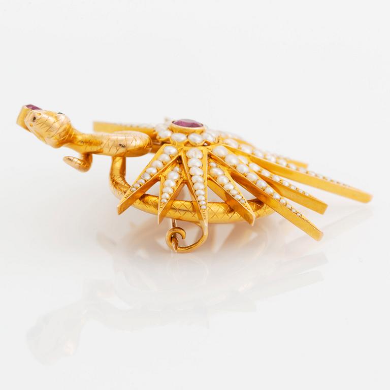 An 18K gold brooch set with two rubies, one of them likely synthetic, and pearls.