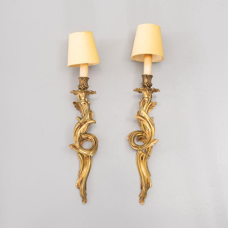 A pair of brass Rococo-style wall scones, first half of the 20th century.