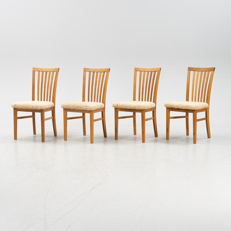 A set of four oak chairs with new  sheepskin upholstery.