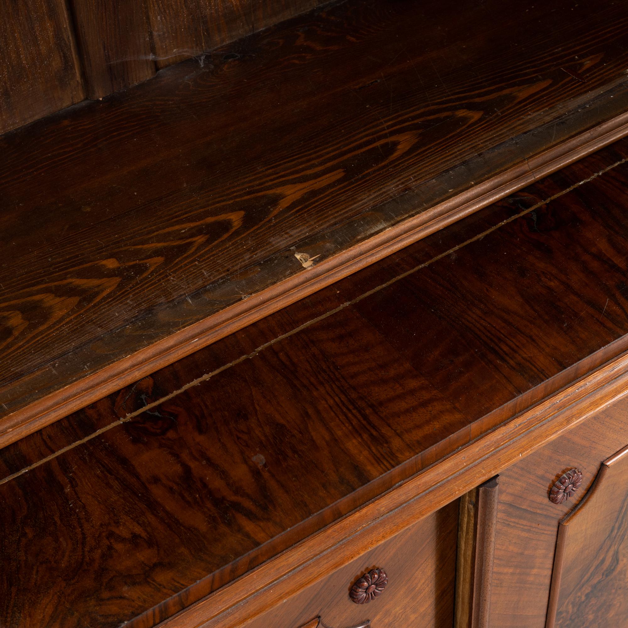 A walnut veneered book cabinet, second part of the 20th Century.