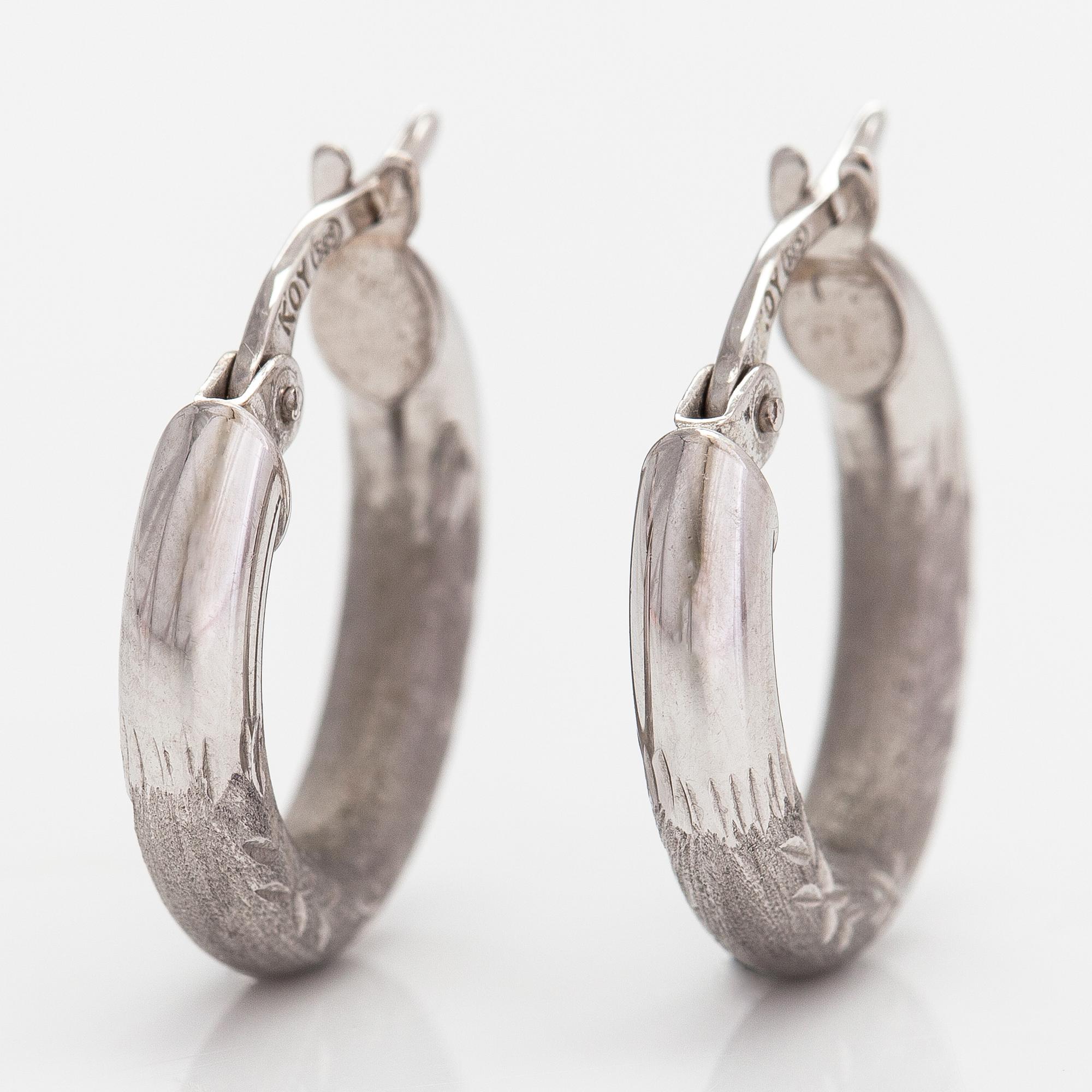 A pair of 14K white gold earrings.