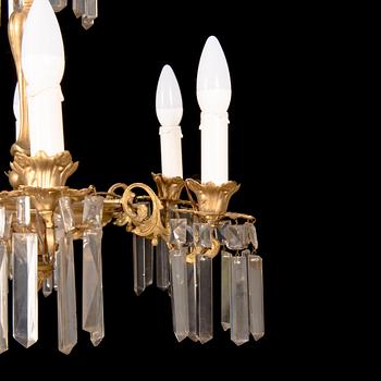 A brass chandelier with prisms, late 19th century. Height 75 cm.