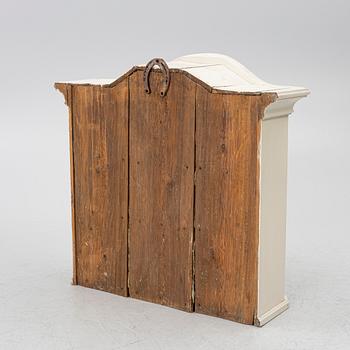 A Swedish rococo hanging cabinet, mid 18th century.