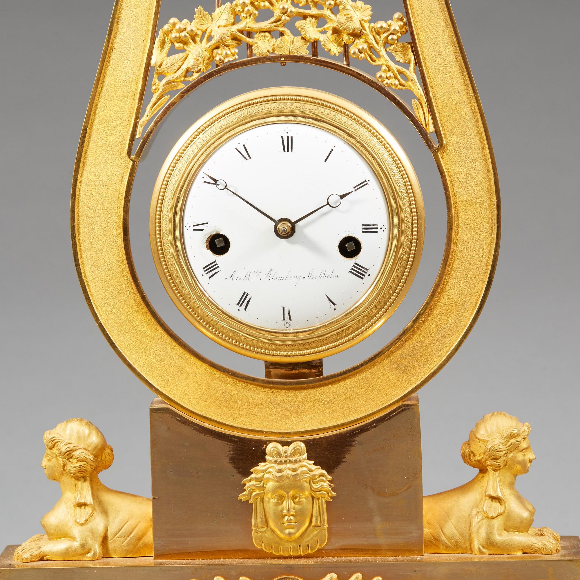 A late Gustavian early 19th century gilt bronze mantel clock.