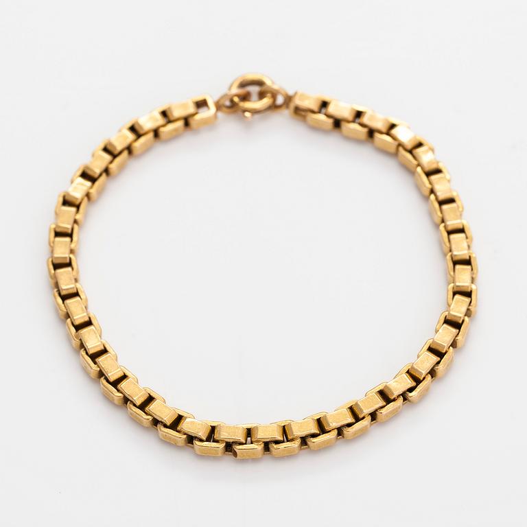 An 18K gold bracelet.