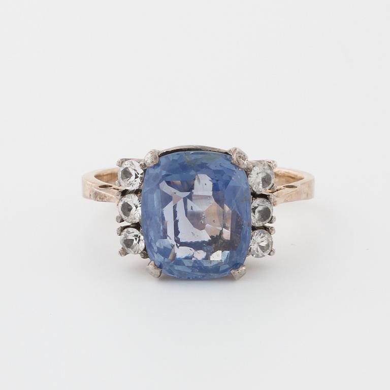 A synthetic sapphire and white gemstone ring.