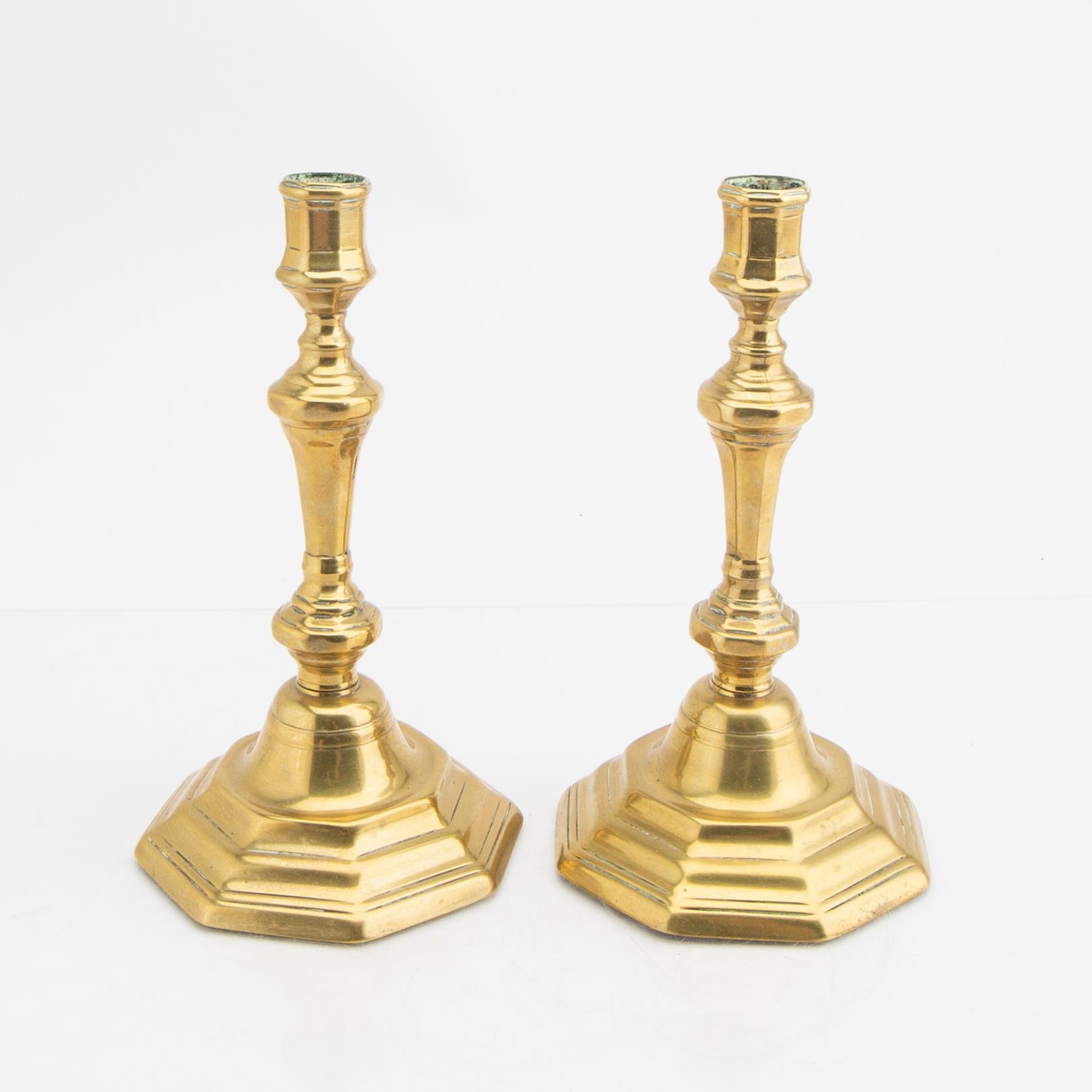 A pair of 18th century brass candle sticks.