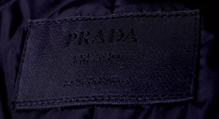 A cape and handbag by Prada.