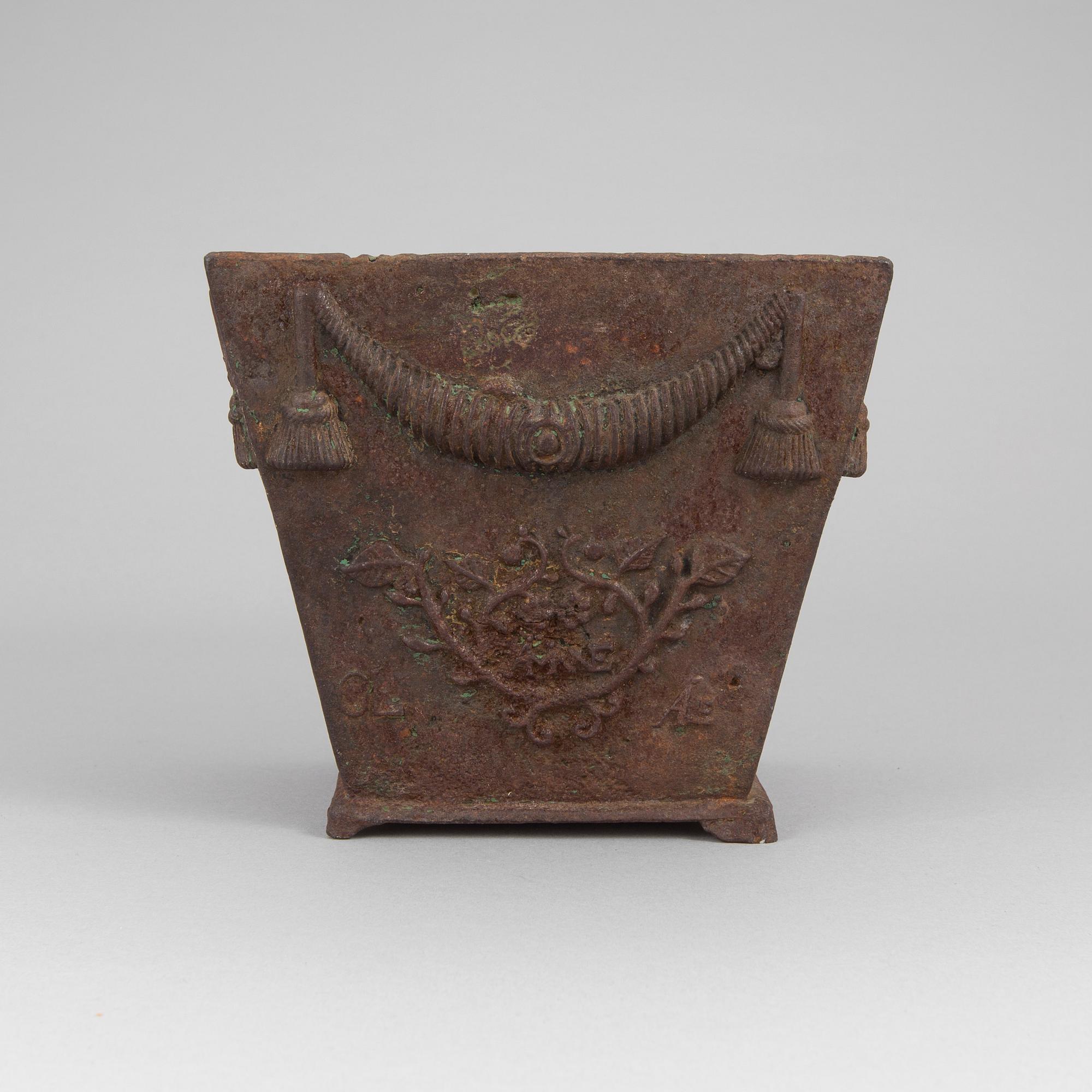 An early 19th century flower pot of cast iron.