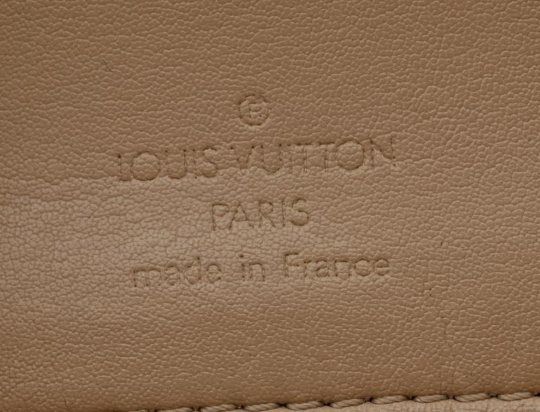 A beige monogram vernis handbag by Louis Vuitton.
