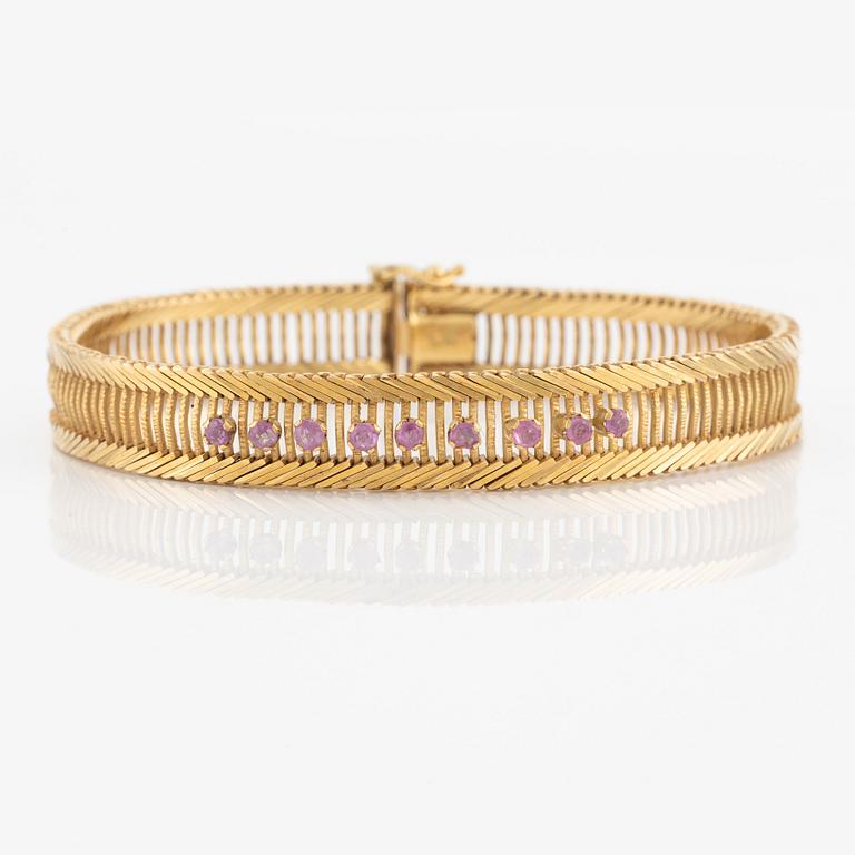 Armband 18K guld med rosa stenar.