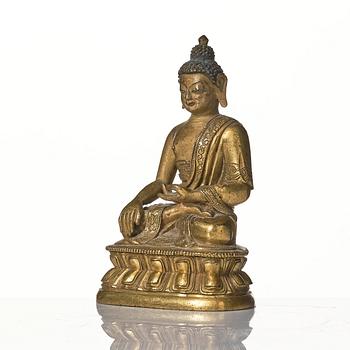 A gilt bronze figure of Shakyamuni buddha, Tibeto-Chinese, 18th century.